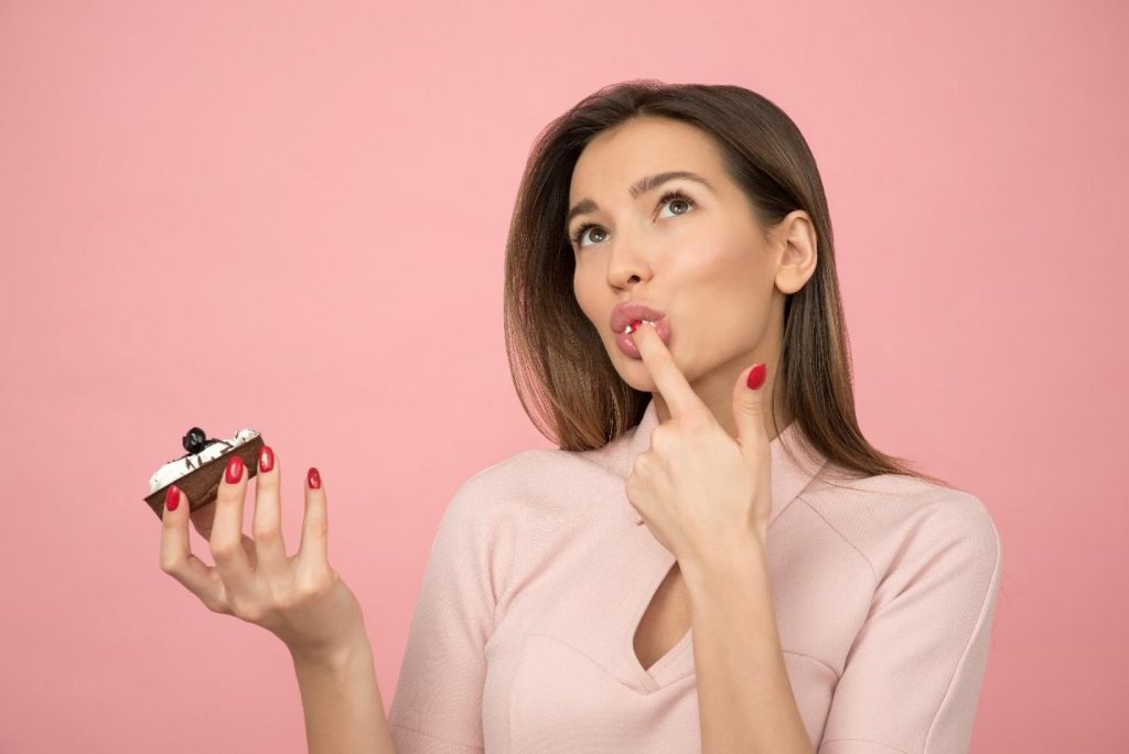 A Woman Tasting a Cupcake